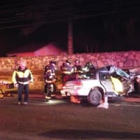 <p>Firefighters work to free the driver</p>