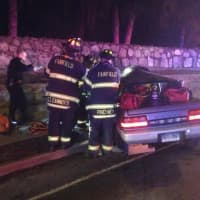 <p>Firefighters work to free the driver, a 27-year-old man. </p>