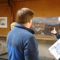 <p>A docent interprets the artwork inside the Young Studio at Weir Farm National Historic Site. </p>