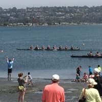 <p>Saugatuck coach Chase Graham (bottom left) stands in the water to exhort his girls crew after it won the San Diego Classic on Sunday.</p>
