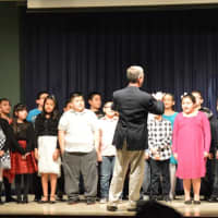 <p>Skip Jennings conducts a choir of his fourth-grade students from Ellsworth Avenue Elementary School. </p>
