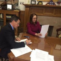 <p>Gov. Dannel Malloy signs the executive order Monday in his office. </p>
