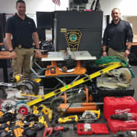<p>Norwalk detectives with the power tools recovered as a result of their investigation.</p>