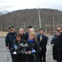 <p>Officials gather for a grade-crossing safety press conference in Chappaqua. The nearby crossing is in the distance.</p>