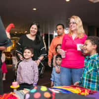 <p>Families enjoying balloon making by a member of Lil Kisses Face Painting.</p>