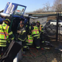 <p>Fairfield firefighters work to free the truck driver. </p>