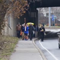 <p>Walkers carry the cross from the First Congregational Church to St. Luke Episcopal on Good Friday.</p>