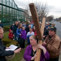 <p>The walkers pause with the cross as the march through Darien to commemorate Good Friday.</p>