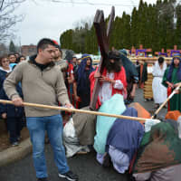 <p>A group gathered in front of Jesus as part of the passion reenactment in Mount Kisco.</p>