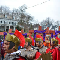 <p>A group of men dressed as Roman soldiers stand in front of several crosses used for the Mount Kisco re-enactment of Jesus&#x27; passion.</p>
