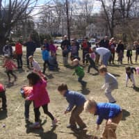 <p>Five-year-old kids push their eggs across the library&#x27;s Great Lawn with wooden spoons.</p>
