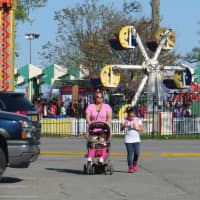 <p>A mother and her two children leave Playland on opening weekend in May 2014.</p>