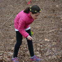 <p>Mount Pleasant&#x27;s Sophia Ivanov, searches with a stick during the Chappaqua Fire Department&#x27;s Easter Egg hunt.</p>