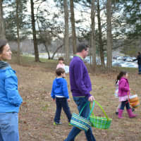 <p>Attendees walk through the woods at Chappaqua Crossing during a local Easter egg hunt.</p>