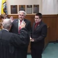 <p>Tuckahoe Mayor Steve Ecklond takes his oath of office with the Rev. Eric Raaser of Immaculate Conception Church.</p>