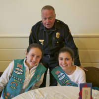 <p>Fairfield Police Department Capt. Joshua S. Zabin enjoys lunch with Scouts Zoe Feay (L) and Emma Fekete.</p>