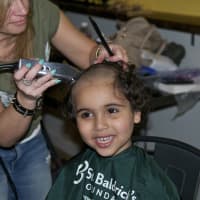<p>A Yonkers Montessori School student gets his head shaved for charity.</p>