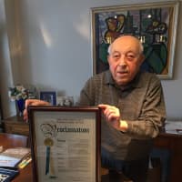 <p>New Rochelle resident Dr. Moshe Avital shows off his Westchester plaque.</p>