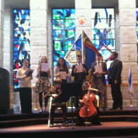 <p>Musicians perform during the annual Holocaust commemoration at Temple Sholom on Wednesday.</p>