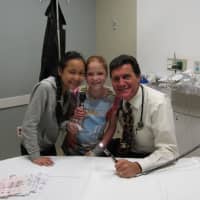<p>Dr. Pete Richel, chief of pediatrics at NWH, and attendees smile for the camera.</p>