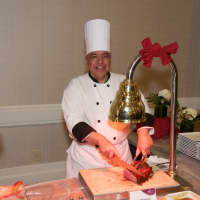 <p>A chef slices meat for the dinner.</p>