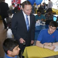 <p>Rob Astorino looks at the work of one of the teams. </p>