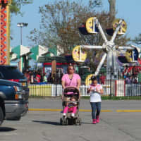 <p>A mother and her two children leave Playland Amusement Park on opening weekend in May 2014.</p>