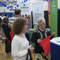 <p>A business exhibitor greets visitors at the Shop Putnam Business and Home Expo.</p>