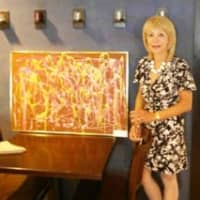<p>Judika Liberman with one of the art works to be exhibited.</p>