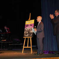 <p>Superintendent of Schools William Donohue and Byram Hills High School Principal Chris Borsari unveil playbill for the newly renamed The Varley Players to Joy Varley, retiring director of fine arts at the school.</p>