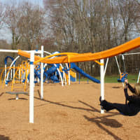 <p>First Selectman Jayme Stevenson takes a turn on the new playground&#x27;s zip line.</p>