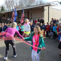 <p>Physical education teacher Jill Cardamone and students Ava Stone, Molly McGuckin and Briggs McGuckin demonstrate their jump rope skills during the dedication ceremony.</p>