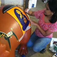 <p>Amrita Majumder of Stamford, draws on her background to create an Indian folk art design of a mother and child.</p>
