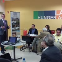 <p>Michael Kelly, sales and marketing manager for PURE Insurance of White Plains, talks to architects and designers at the Food Bank For Westchester.</p>