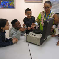 <p>Gina Levon Simpson of Bridgeport shows off an old record player to her students in the Children&#x27;s Leadership Training Institute. </p>