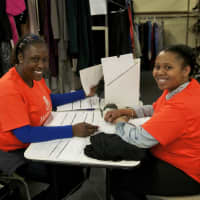 <p>Students Annania Titus, left, and Stephanie St. Preuve work at LifeBridge&#x27;s Community Closet.</p>