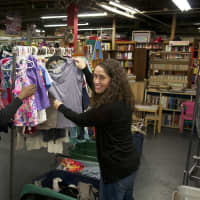 <p>Director of Student Activities Kelly K. Hope, left, and Karyn Smith, assistant professor of English, work with students in the Community Closet.</p>
