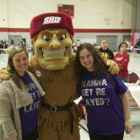 <p>Students pose with Sacred Heart&#x27;s mascot Big Red.</p>