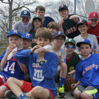 <p>Players and families come out Sunday for Darien Little League&#x27;s opening day ceremonies. Here players pose on top of a dugout with hotdogs in hand. </p>