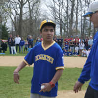 <p>Sid Verma, a member of the Challenger program, throws out the first pitch.</p>