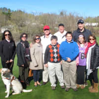 <p>Al Maiolo, back row left, surrounded by family, is congratulated by Michelle Brier, Guiding Eyes for the Blinds director of marketing and communications, front row left, and Guiding Eyes dog Darien.</p>
