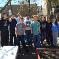 <p>Members of the Horace Greeley High School Habitat Club gather at one of their Yonkers volunteer projects.</p>