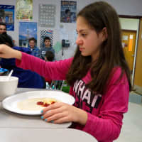 <p>Briarcliff Middle School French student  puts finishing touches on a crepe.</p>