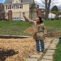 <p>Drew Shuptar-Rayvis blesses the garden before planting begins.</p>