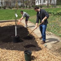 <p>Students begin laying down mulch for the permaculture garden.</p>