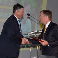 <p>Paul J. Massey Jr., right, receiving the 2015 Outstanding Vision and Commitment to Action Award from Bridges to Community Executive Director John Hannan.</p>