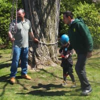 <p>Almstead foreman and climber Mike Perez and climber Hugo Rosa assist a junior climber at Wave Hill Public Garden and Cultural Center in the Bronx.</p>