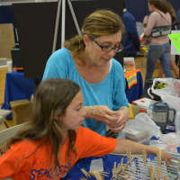 <p>Bonnie Penn, a mother of twin girls who are third graders at Westorchard Elementary School, is with her daughter, Haley, at an exhibit. </p>