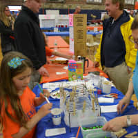 <p>Bonnie Penn, a mother of twin girls who are third-graders at Westorchard Elementary School, is with her daughter, Carly, at an exhibit. </p>