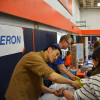 <p>Regeneron&#x27;s table at the Chappaqua STEM Fest. Twenty-five companies were reported to have been involved with the event.</p>